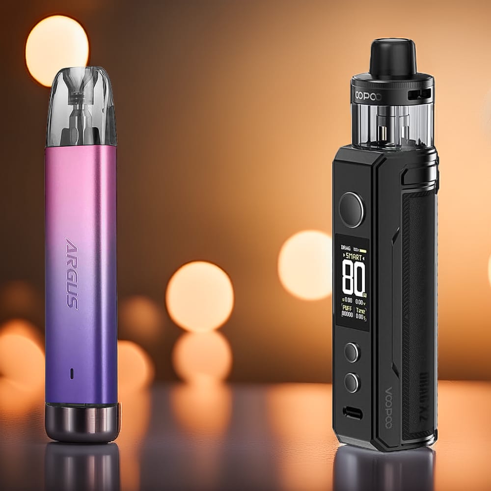 Le DRAG X2 noir et l'ARGUS G2 Mini violet-rose de Voopoo sur fond ambré avec bokeh, illustrant le contraste des designs et la complémentarité du duo